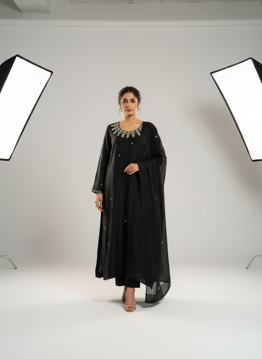 Model wearing black embroidered outfit