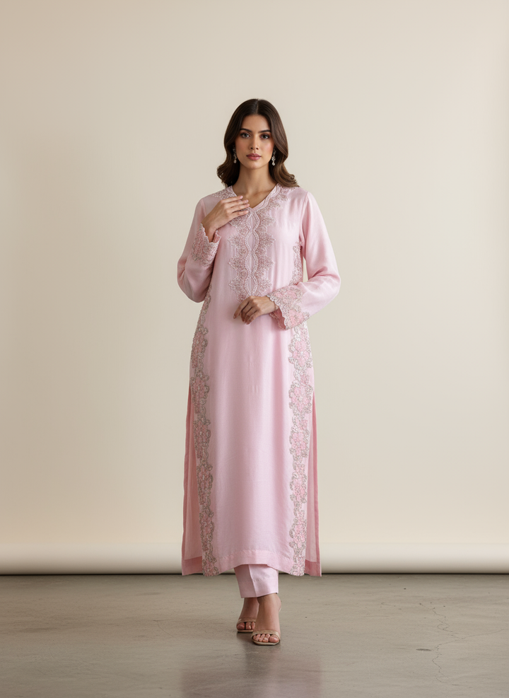 Model wearing pink embroidered outfit